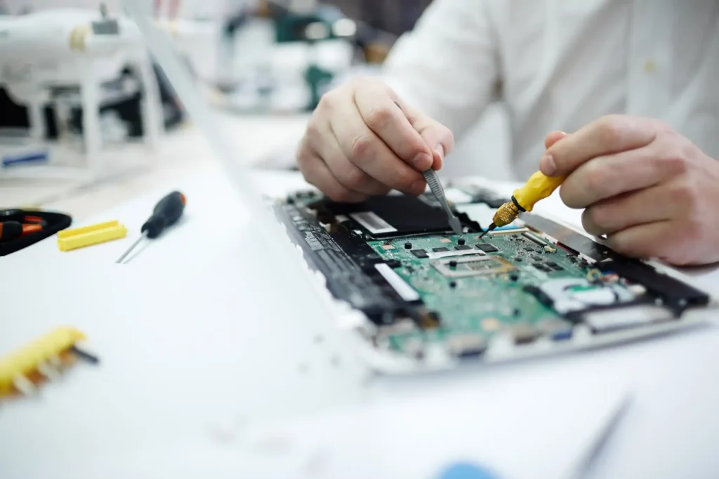 Technician repairing a laptop circuit board