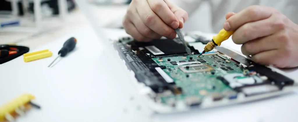 Technician repairing a laptop circuit board