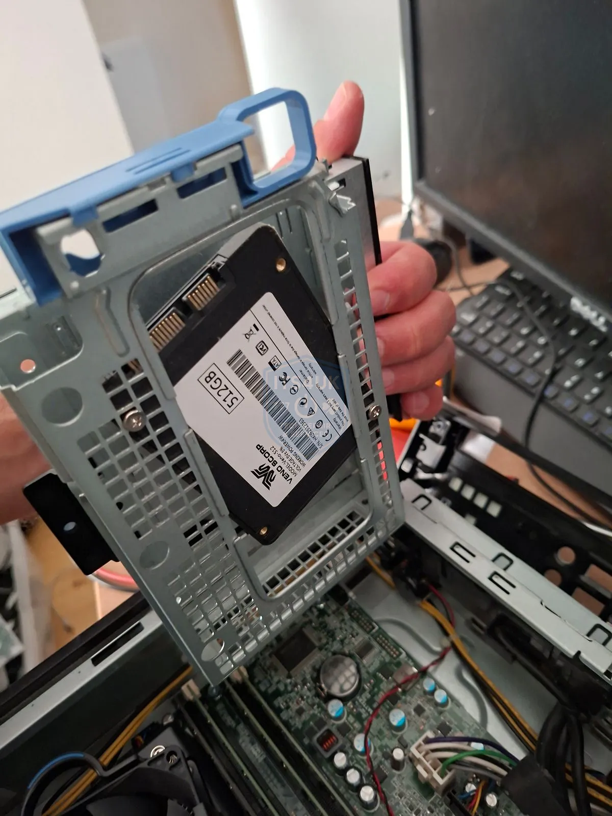Removing a hard drive caddy from a desktop computer during a data recovery job